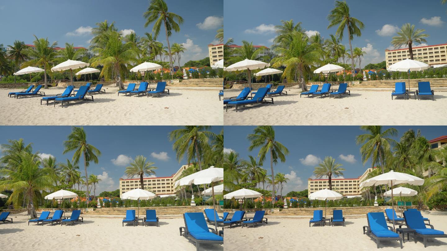 泰国华欣白色沙滩上，沙滩椅上挂着阳伞。