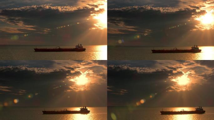 航空货船在海上航行，阳光穿过乌云