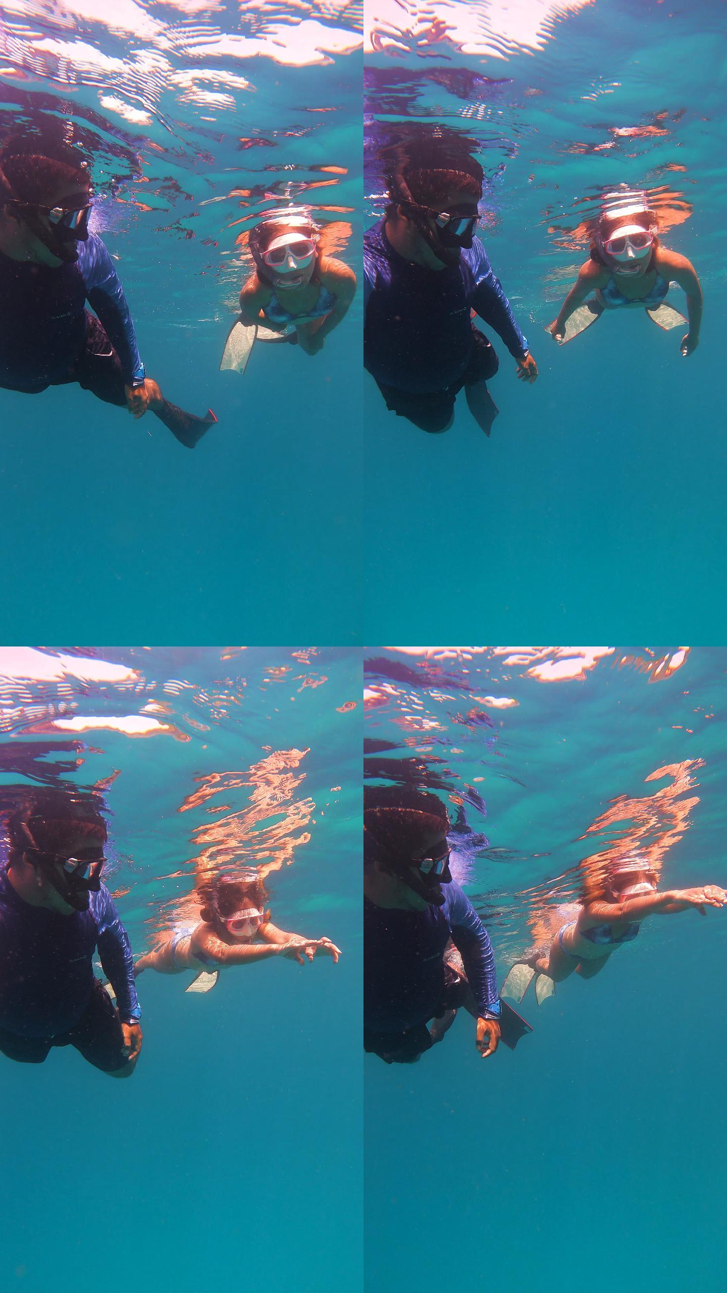 4K年轻夫妇自由潜水员穿着长鳍自由潜水皮肤潜水在海里浮潜