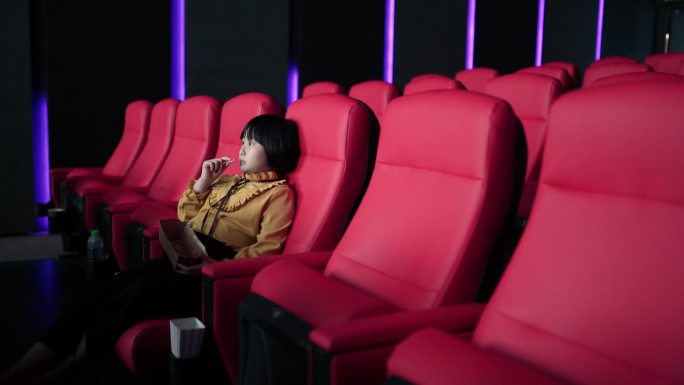 中国亚裔女孩独自在电影院看电影