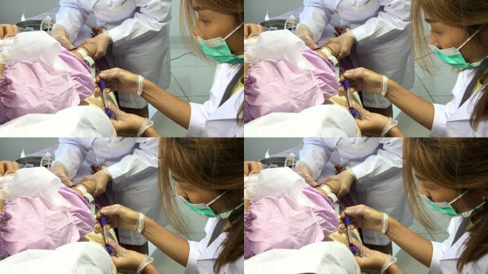 中国亚裔女护士在临床上从中国女性患者手臂静脉采血到试管中