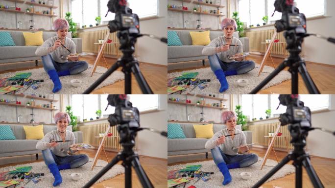 女艺术家用相机在绘画上拍摄视频日志