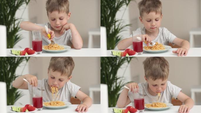 厨房里的小男孩在家吃意大利面时微笑着。好孩子胃口概念