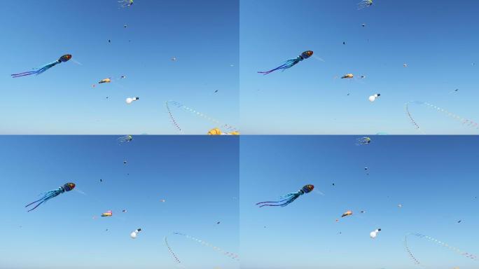 风筝在晴朗的蓝天上飞翔。童年的乐趣。