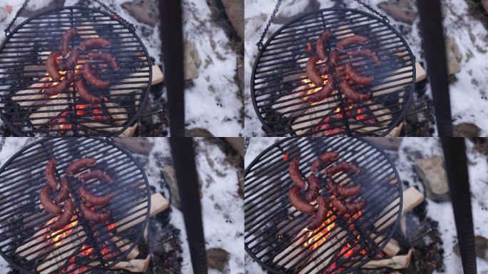 后院篝火上烤香肠的镜头。