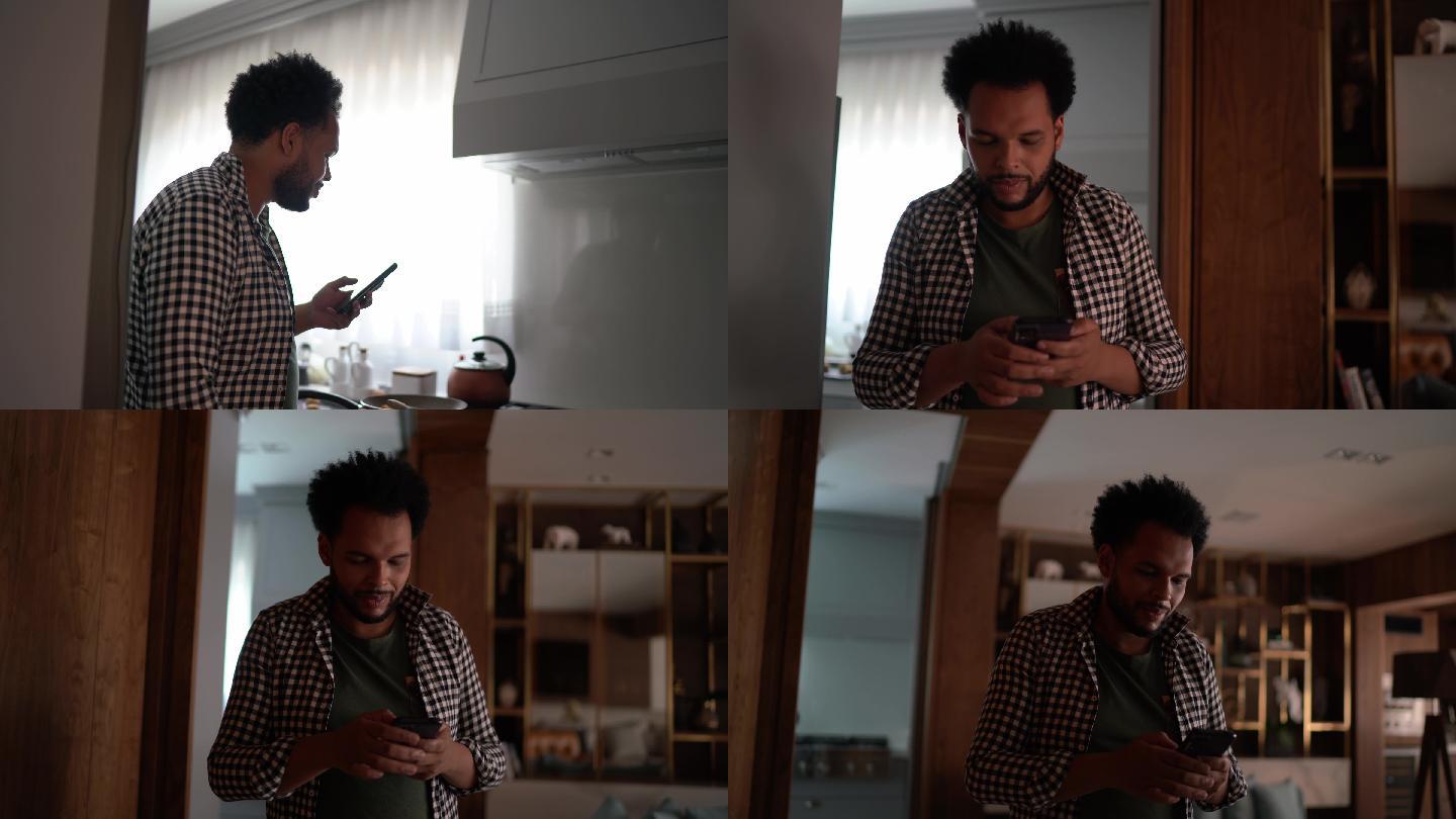 男人在家里用智能手机走路和发短信