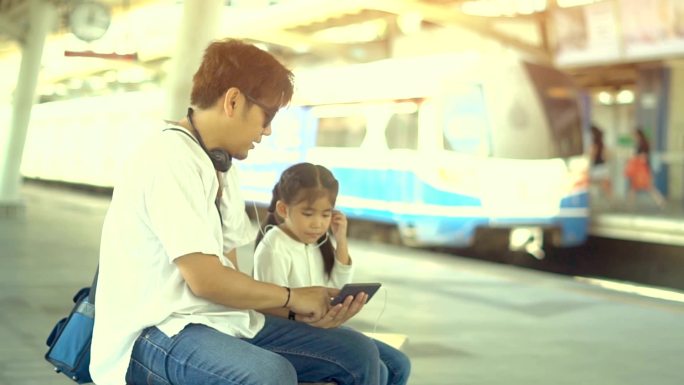 火车站单亲爸爸或单亲继父和女儿触摸屏手机