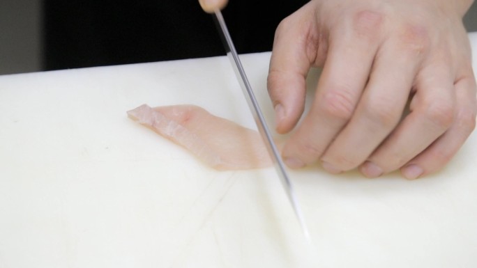 厨师用刀精细切割寿司用的金枪鱼片