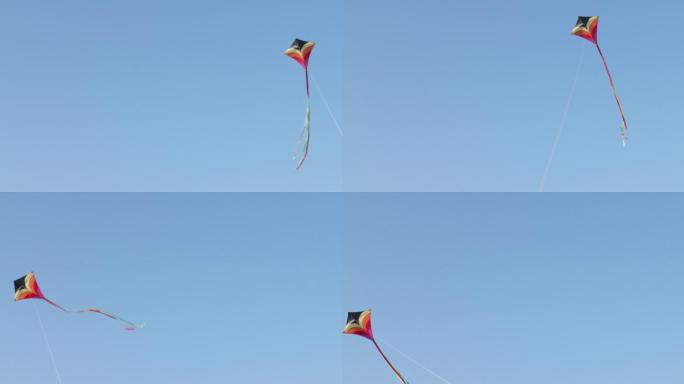 远景：风筝在蓝天上飞翔