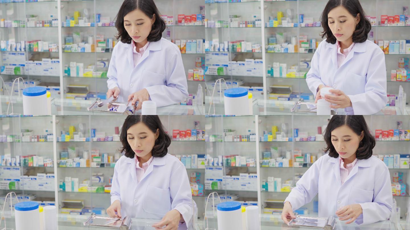 药房背景中的亚洲药剂师肖像。药剂师微笑着看着药房里的摄像机，用药盘数药丸并分发给患者。医疗保健和医疗
