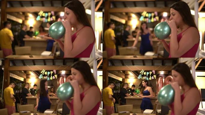 一位年轻女子在生日派对上吹气球的肖像