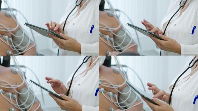 医生在检查患者时使用数字平板电脑的特写镜头