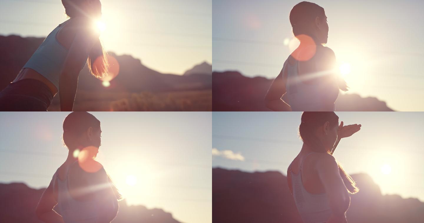日落时分，一名年轻女子在乡村公路上奔跑的4k视频片段