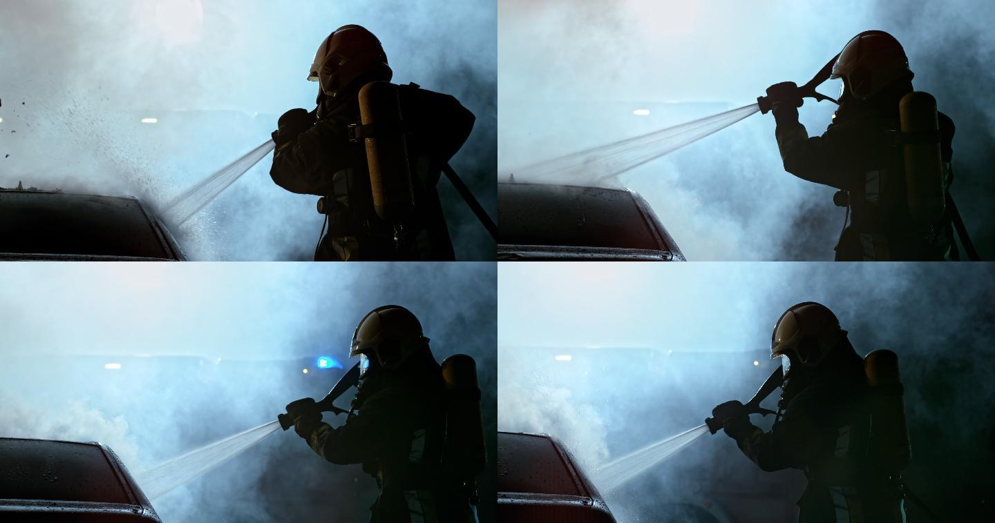 斯洛莫消防队员在夜间用水将烧毁的汽车淋得湿透