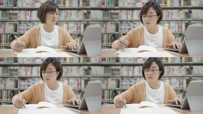亚洲女性在图书馆使用笔记本电脑