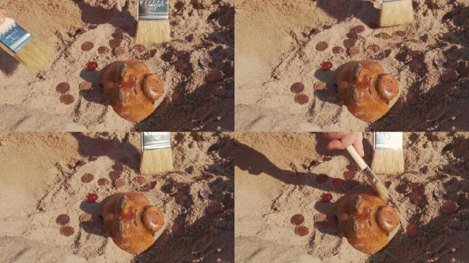寻宝。孩子们扮演考古学家，挖掘隐藏在海滩沙滩上的旧小猪存钱罐，并挑选硬币。