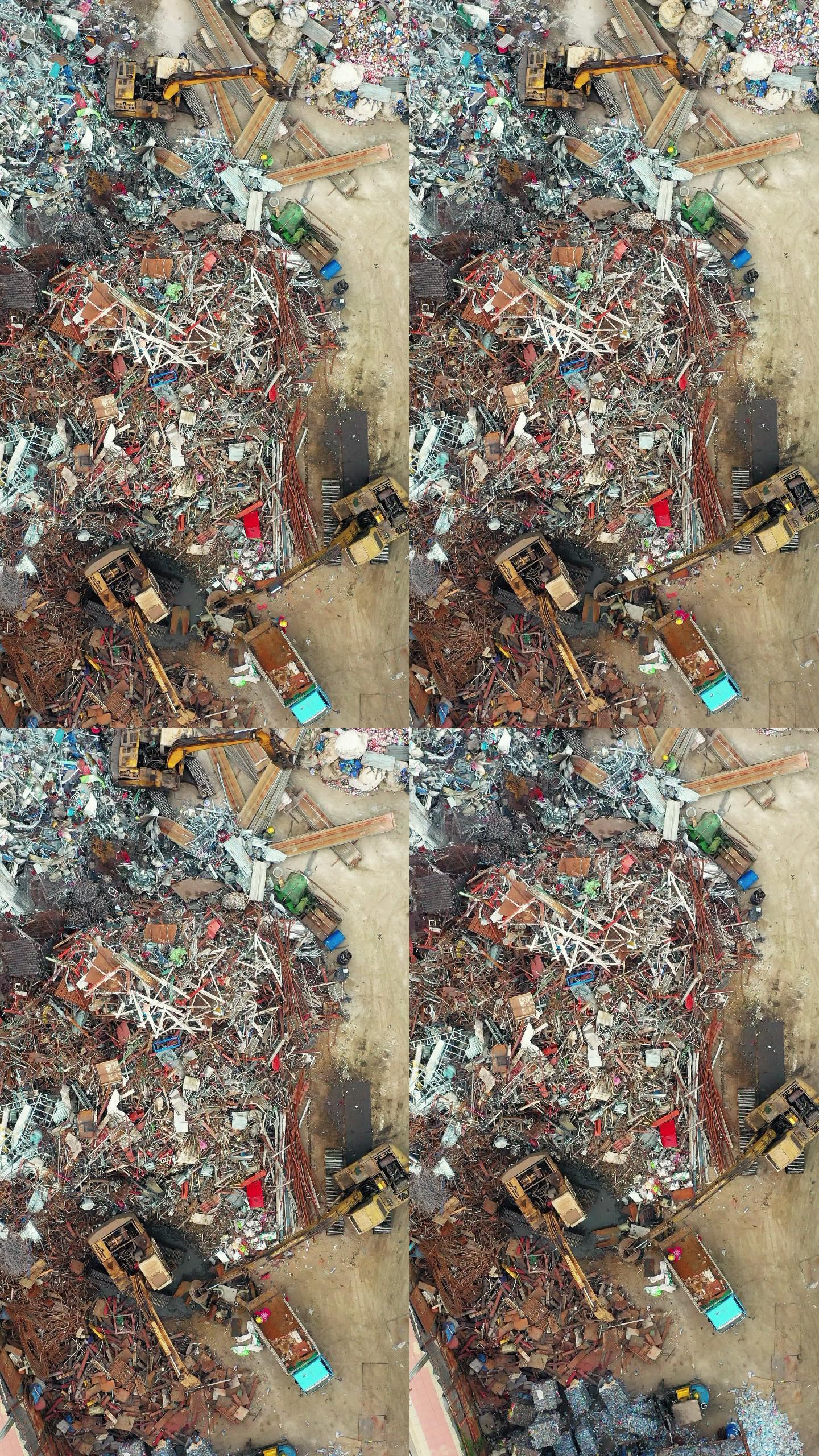 带挖掘车辆和工人的回收工业工厂鸟瞰图