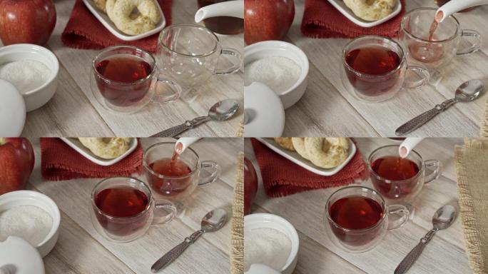 高角度特写镜头，一位女士双手在白色乡村桌子上的杯子里倒着芙蓉热茶