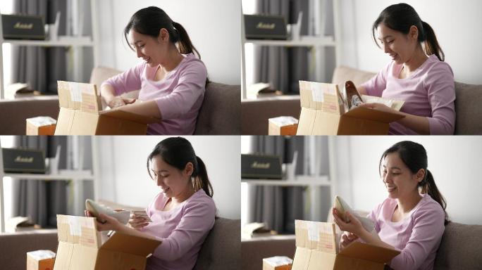 兴奋的年轻亚洲女性客户在家打开包裹盒