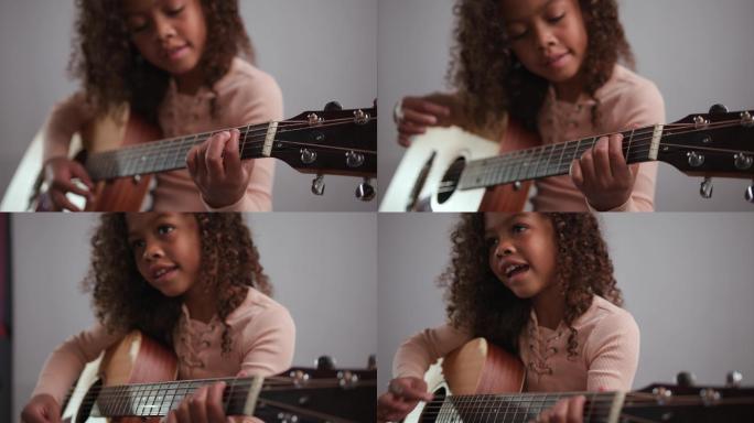 学习弹吉他的年轻女孩