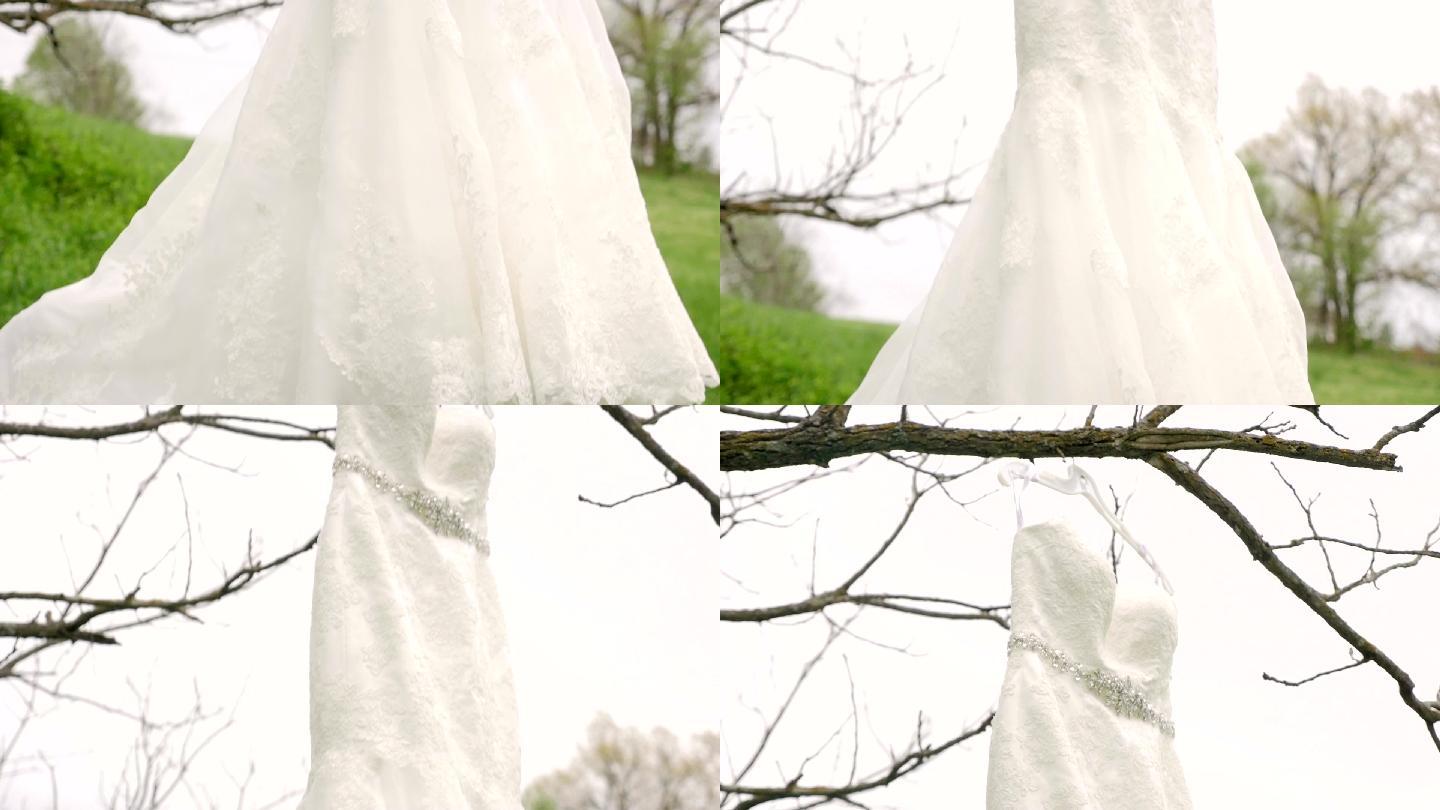 婚礼礼服悬挂在树上，向上倾斜