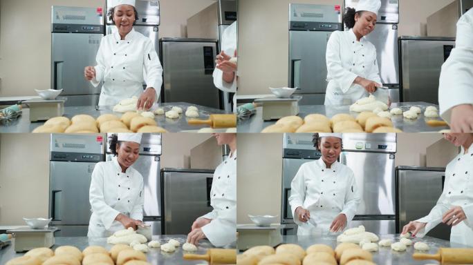 在商业面包房厨房，穿着厨师白的非洲和亚洲年轻女厨师一起愉快地交谈、揉捏、称量和准备面包和馒头的面团
