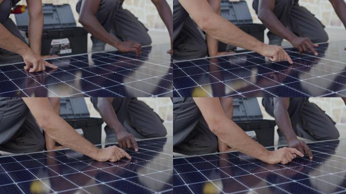 无法辨认的多种族工人正在安装太阳能电池板