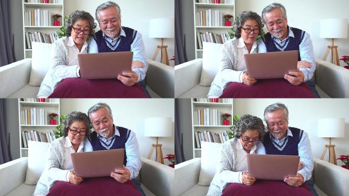 这对年长的夫妇打开笔记本，与家人进行视频通话。