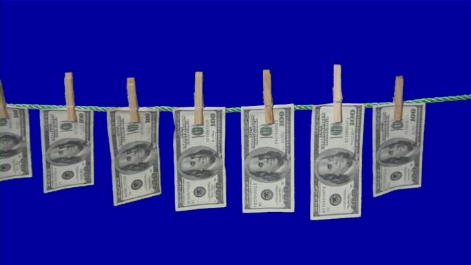 挂在晾衣绳上的美钞。洗钱概念。现金
