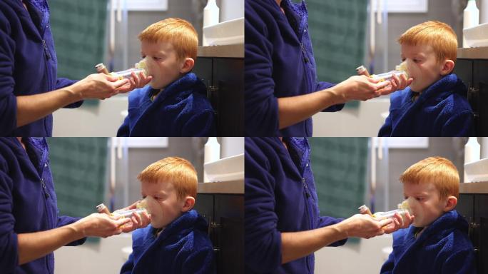 小红发男孩接受母亲的呼吸性哮喘治疗