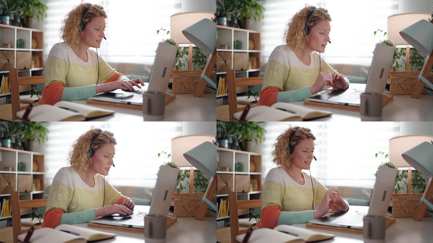 在家庭办公室，女性调度员一边工作一边使用耳机和笔记本电脑