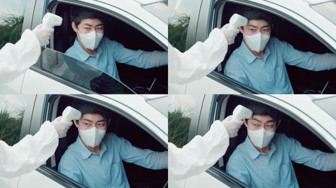 一名年轻男子驾车前往鼻拭子检测是否可能感染冠状病毒。