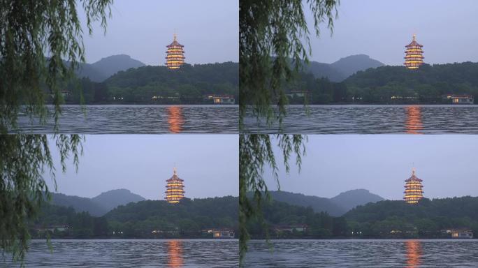 暮色下西湖风景区青山绿树中雷峰塔