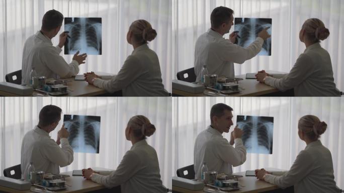 坐在办公桌上的医生向女性患者解释肺部症状