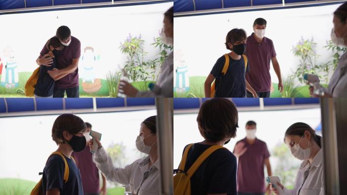 老师在进入学校前测量学生的体温并在其手上涂抹洗手液-使用面罩