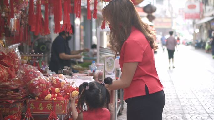 亚洲华人家庭在中国市场购物庆祝中国新年。