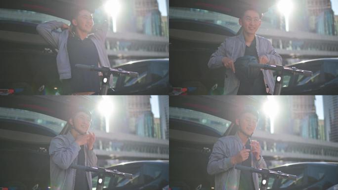 早上，一名亚裔中国男子准备在城市中的汽车行李箱前驾驶推式滑板车