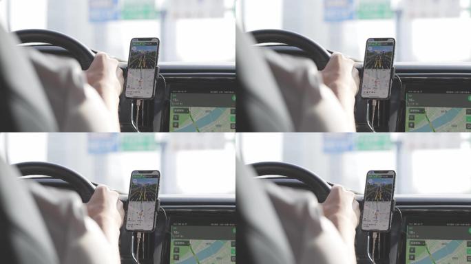 网约车司机按照手机上导航行驶在城市道路上
