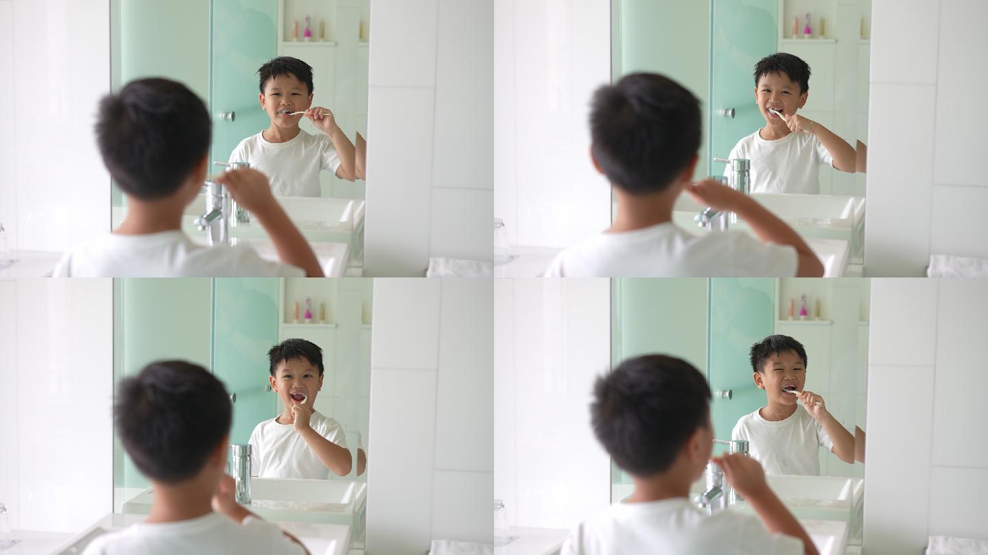 亚洲小孩在洁白干净的浴室刷牙。日常健康和牙科护理的概念
