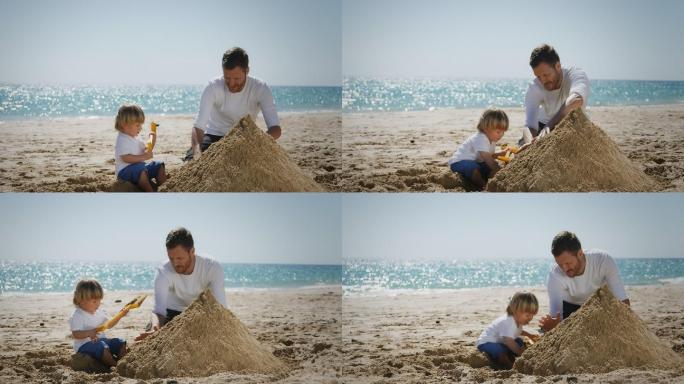 海滩上的父子父子堆城堡沙滩城堡父子海边做