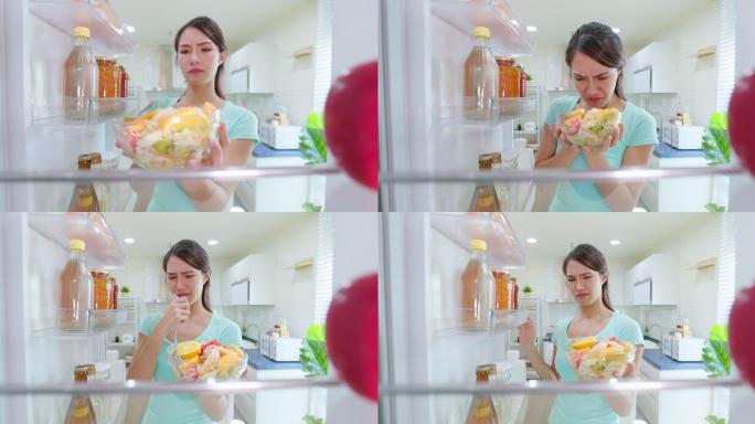 女士打开冰箱食物变质食物过期食物变味