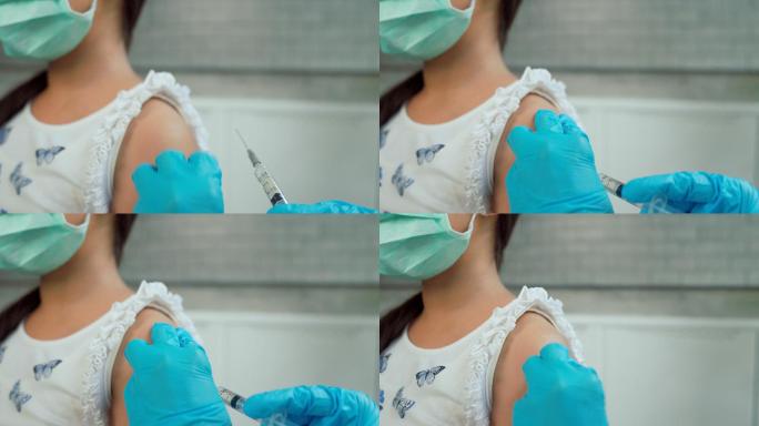 医生给女孩接种疫苗。