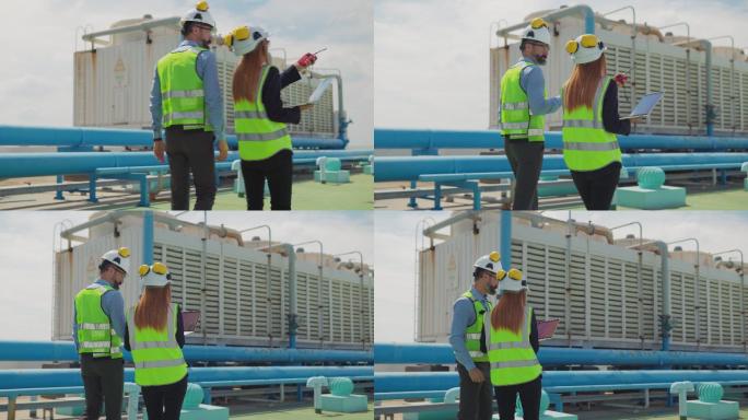 两名维修工程师，男，女，检查大楼露台上的工作，维护大楼的空调系统