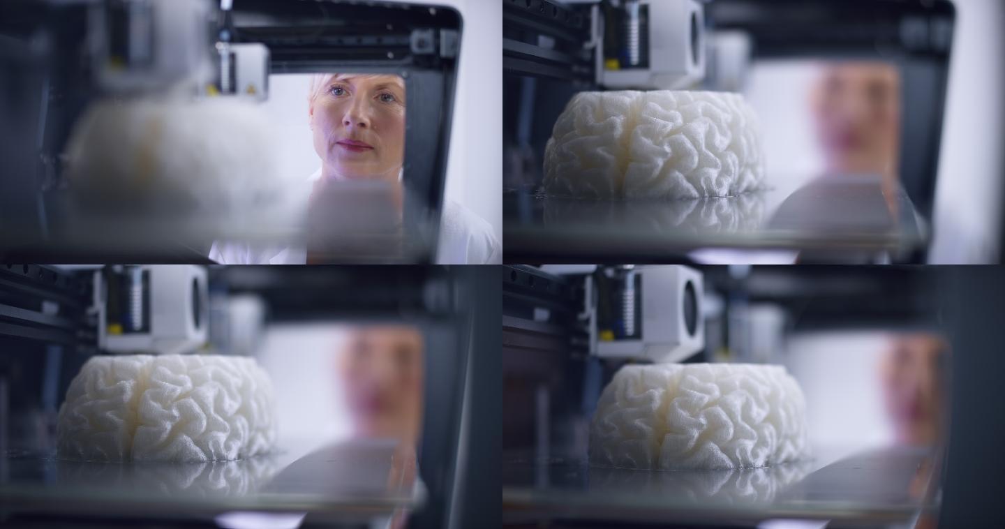 LD高加索女性生物医学工程师在3D打印机中俯瞰大脑模型的构建