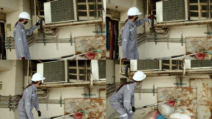 亚洲女技术员检查员检查建筑物内的空调泄漏。工程师女性触摸