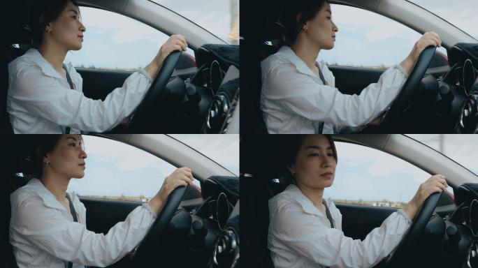 亚洲女商人开车白领女司机滴滴打车