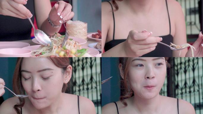 美女在餐厅吃木瓜沙拉或松潭——泰国街头美食