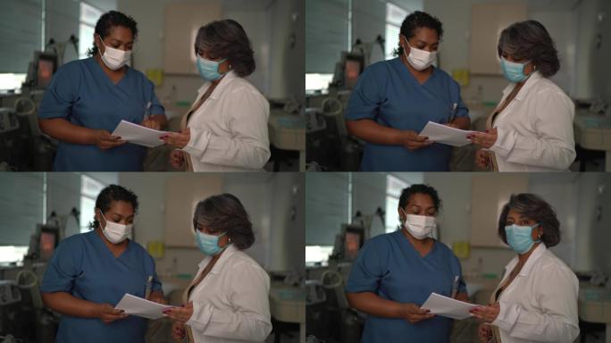 手术室护士和医生使用面罩的肖像