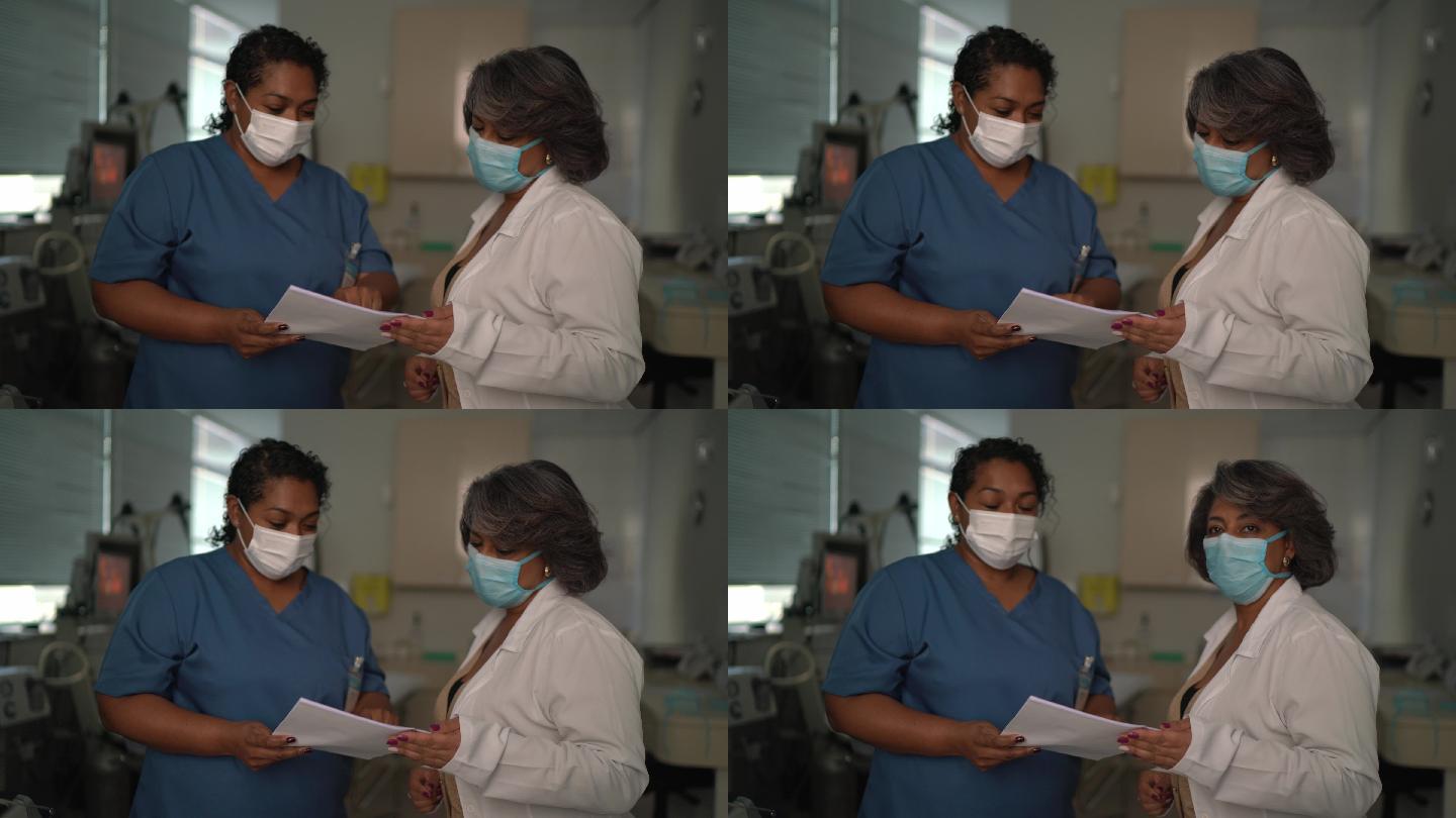 手术室护士和医生使用面罩的肖像