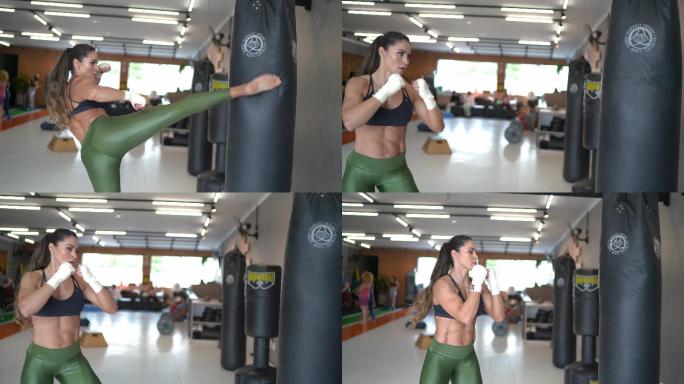 自信的女拳击手在健身房练习
